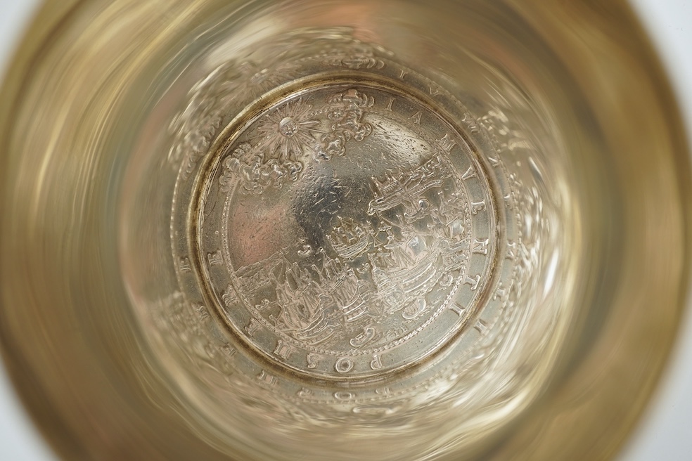 A white metal beaker the base inset with a silver medal commemorating the Peace of Oliva, 1660, Obv. Bird's-eye view of the city of Danzig with troops moving in foreground; above, an eagle crowned, an olive branch in its